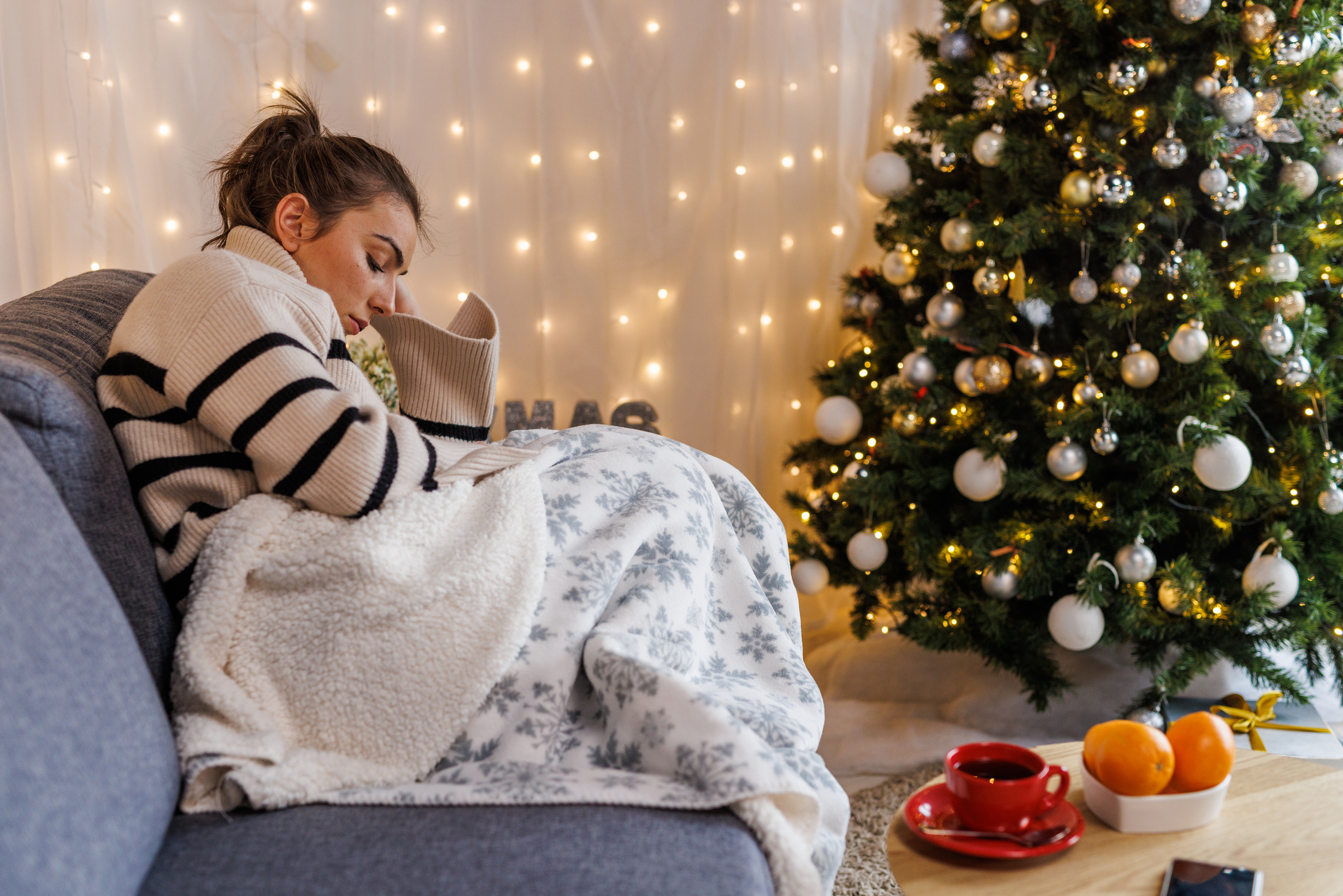 Sad young woman contemplating about Christmas holidays